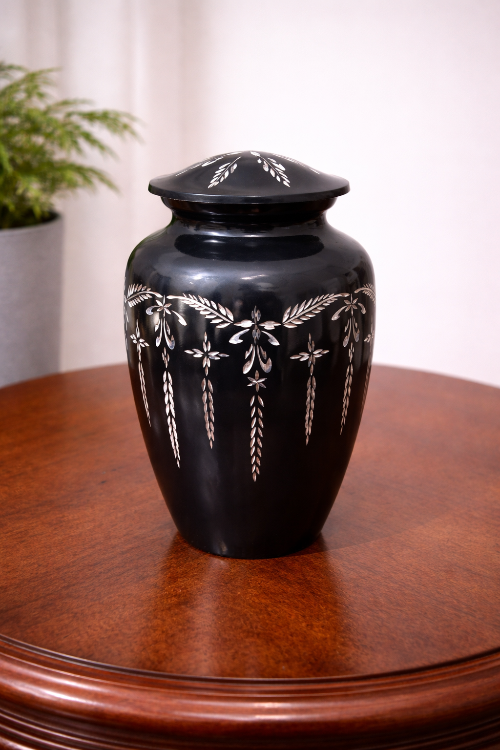 Elegant black aluminium cremation urn with handcrafted silver floral inlay