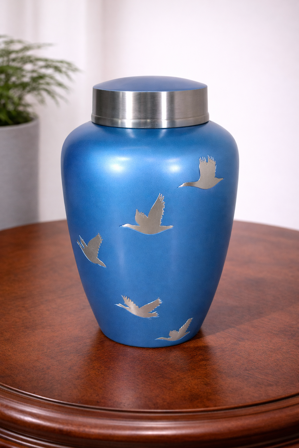 Elegant blue aluminium cremation urn featuring flying bird artwork