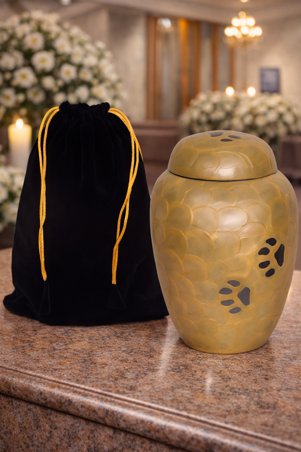 Elegant brass pet cremation urn with textured gold finish and paw print