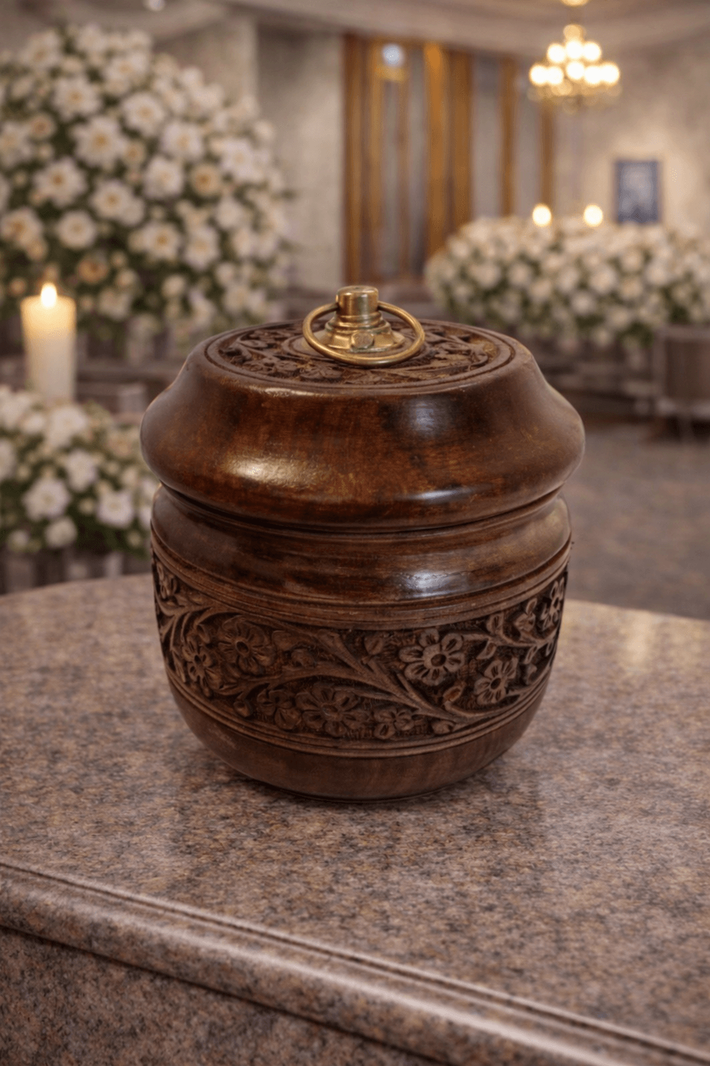 Hand-carved wooden memorial urn with floral detailing and brass ring lid