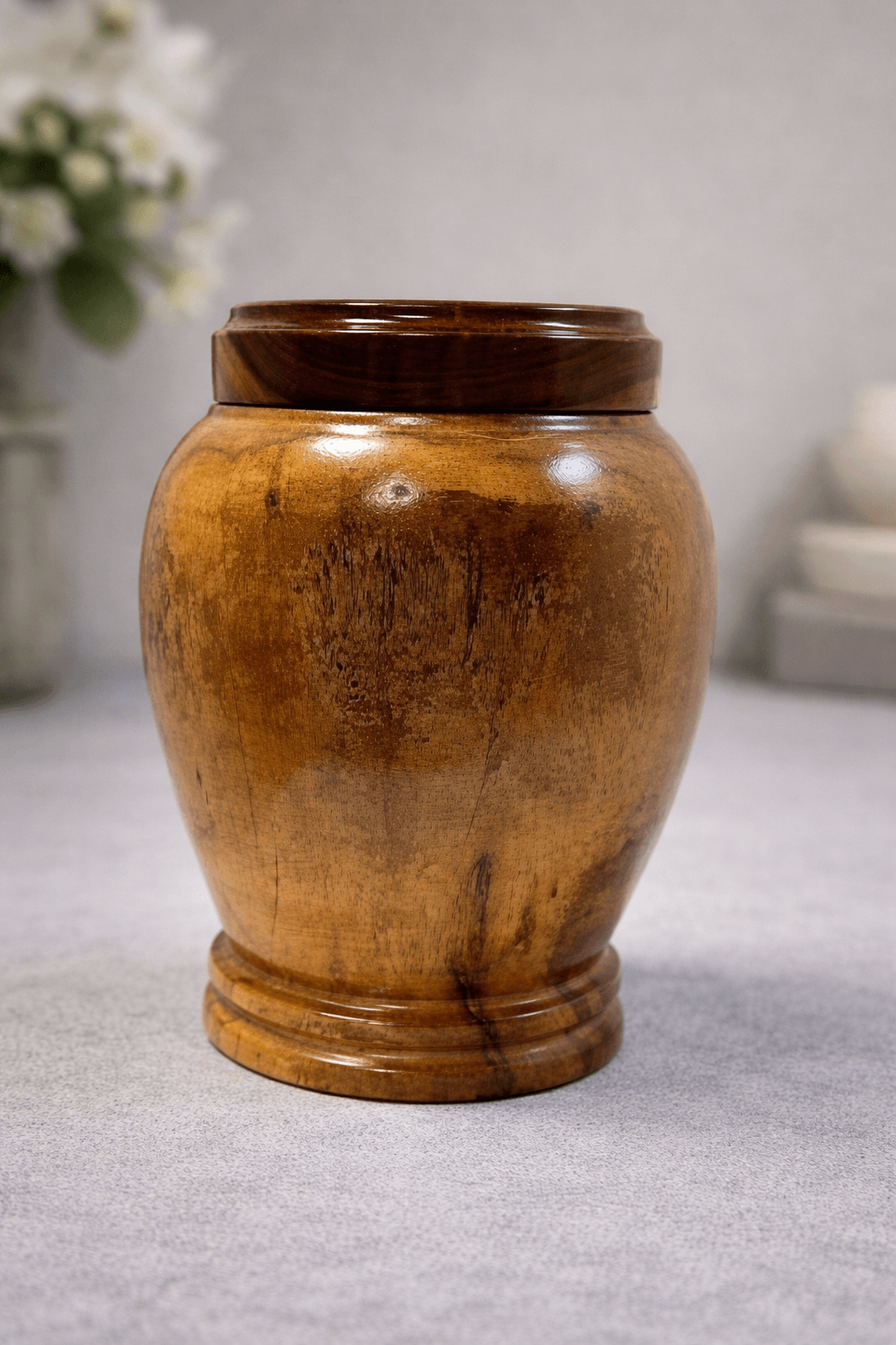 Elegant handcrafted wooden urn with a natural polished finish