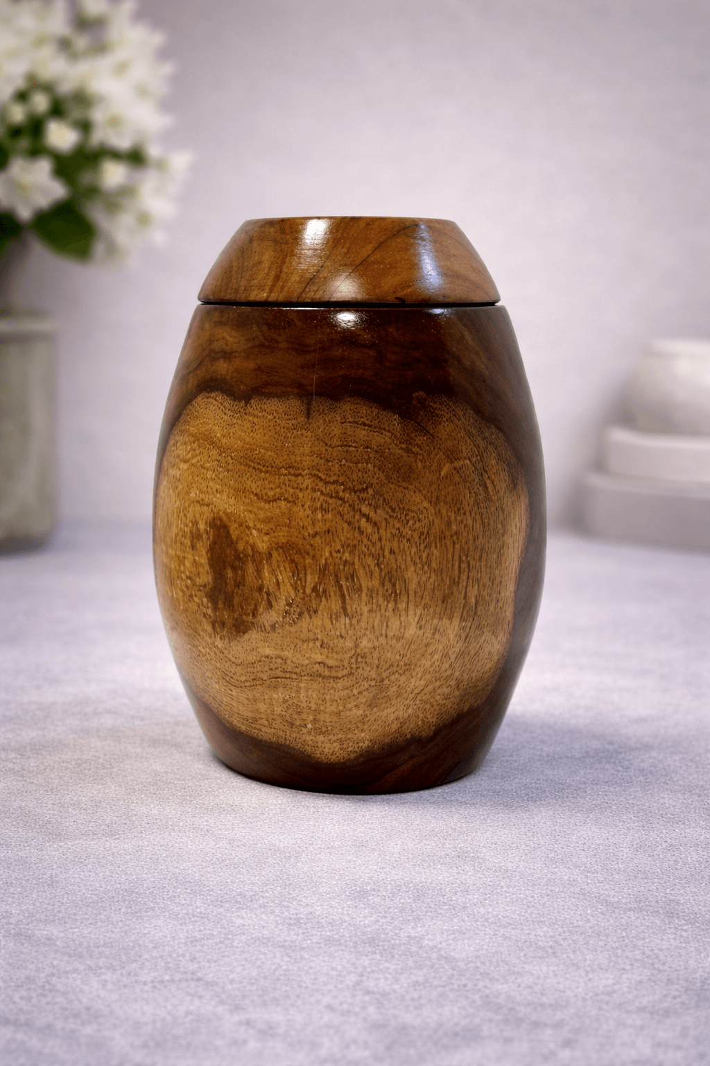 Minimalist handcrafted wooden urn with natural grain finish