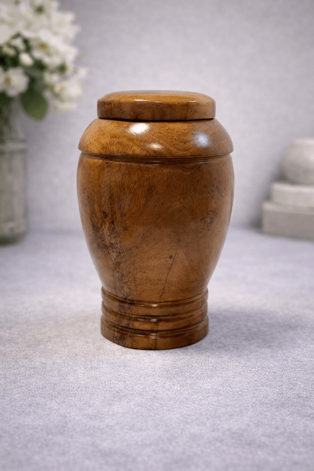Handcrafted solid wood urn with a smooth polished finish and classic shape