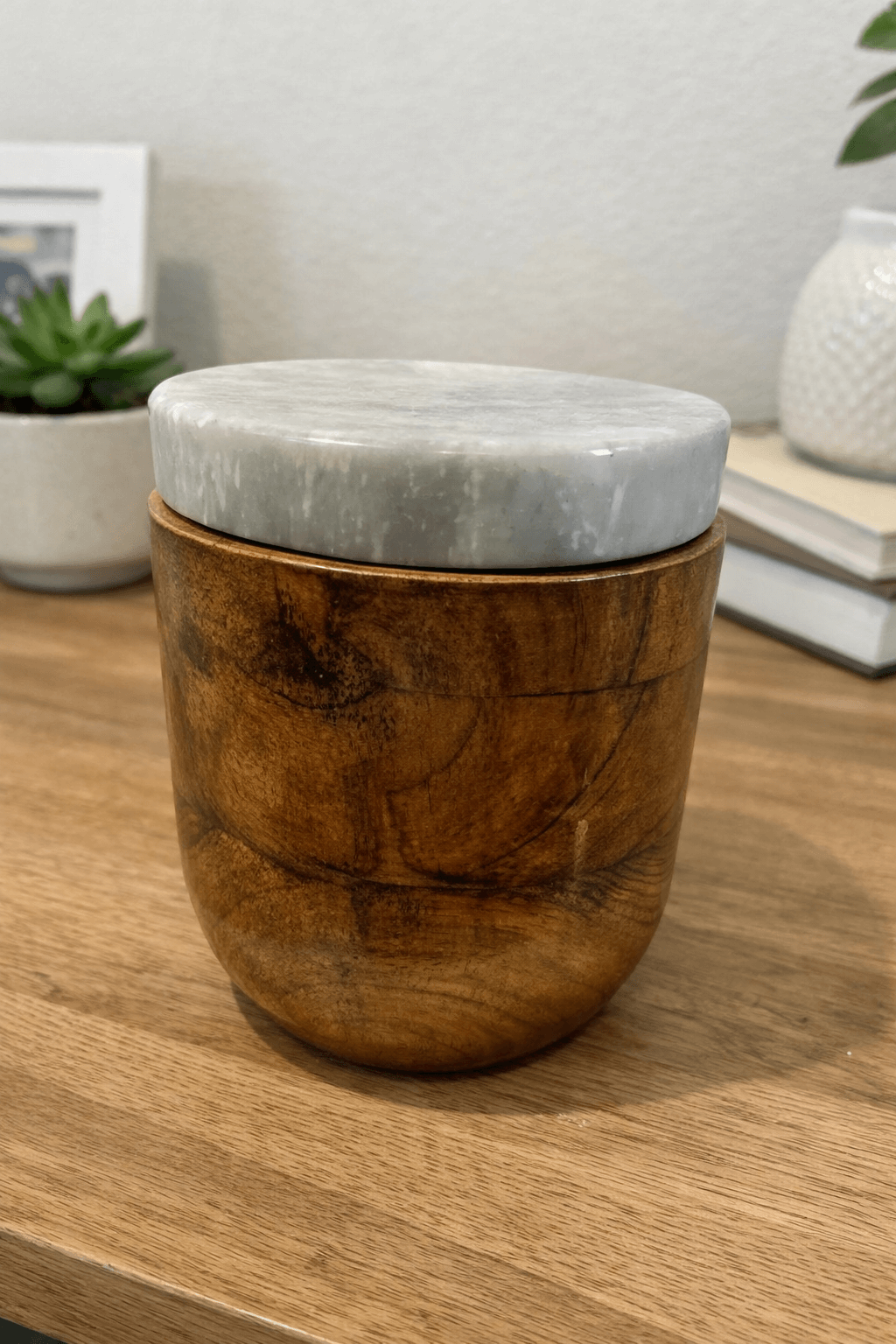 Handcrafted wooden urn with elegant marble lid and natural grain finish